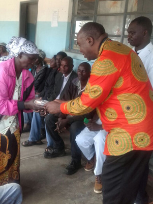President Kambani Presenting a solar light to a deserving Traditional Birth Attendant