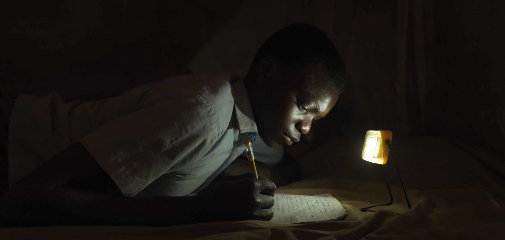 Derrick is able to complete home work after dark due to accessing the rural schools 'light library'