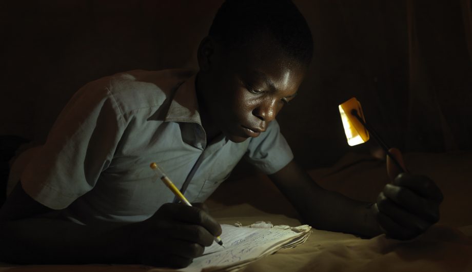 Derrick completes his homework after dark.