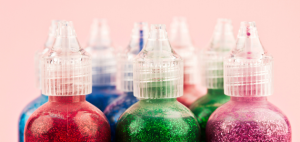 A front-on view of 8 bottles of glitter.