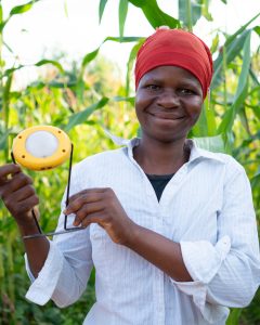 Liness looks to camera holding her solar light proudly.