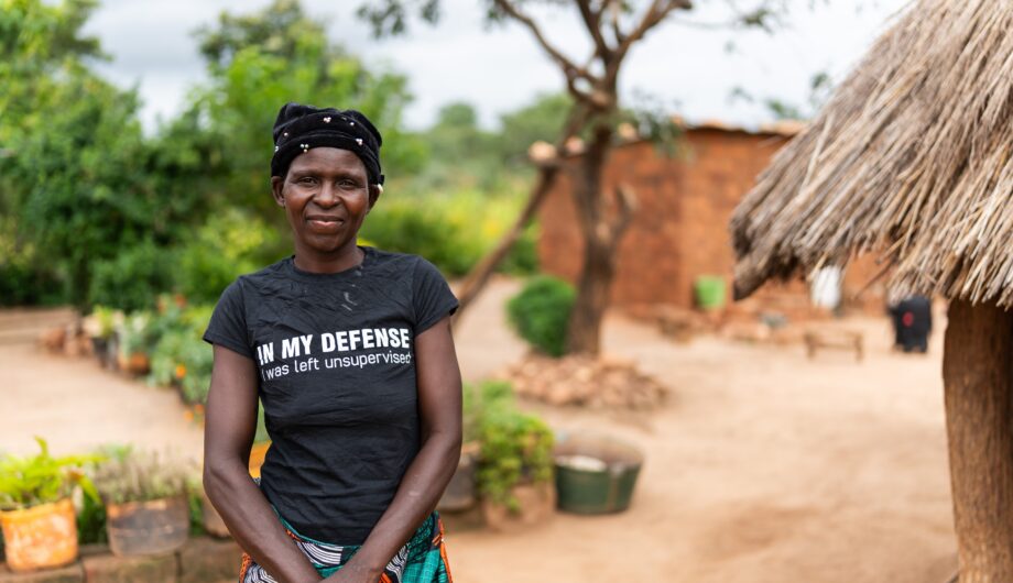Fridah Luputa Mwale standing outside her home in Chipungu village, Zambia.